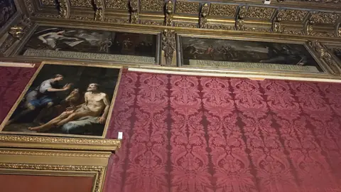 Red damask, gilt, and a ceiling doing most of the talking.