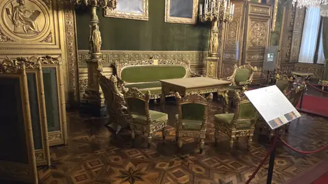 The dining room, laid as though somebody were coming.