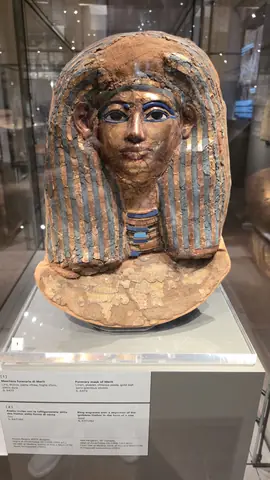 A painted mask, looking straight back at you.