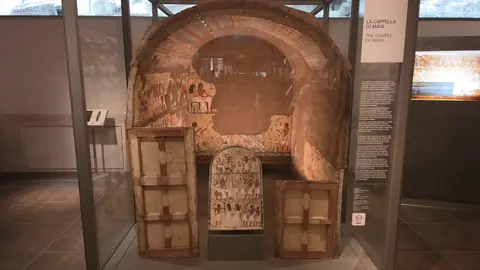 A reconstructed tomb chamber, put back together indoors.