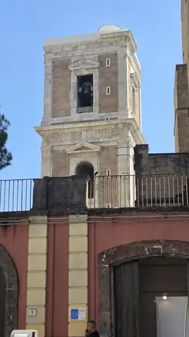 A bell tower going up out of the alleys.