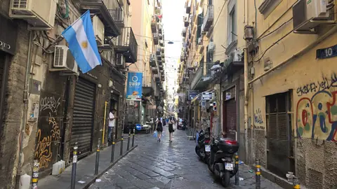 Flags, scooters, shrines and shop fronts, all in four metres of width.