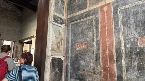 Frescoes in a front room, framed like pictures.
