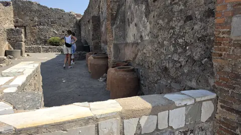 Amphorae stacked against a wall.