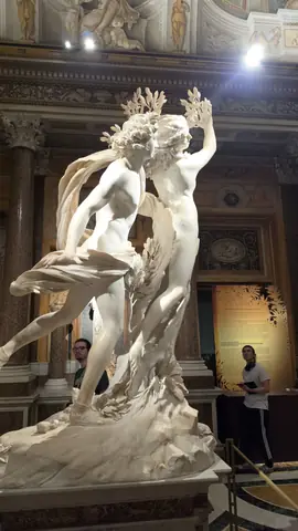 Apollo and Daphne, caught at the exact moment she turns into a tree.