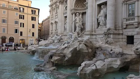 The Trevi Fountain at ten to seven, from the one angle that keeps the crowd out of it.