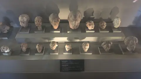 Busts in a case — a room's worth of Roman faces.