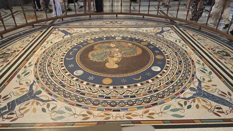 The floor mosaic laid out underneath it.