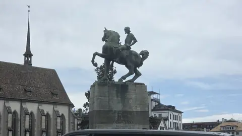 A bronze horseman in front of the church.