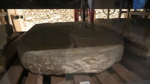 A stone basin, worn smooth.